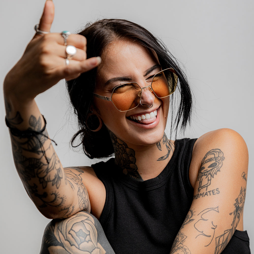 Happy young woman with piercings and tattoos