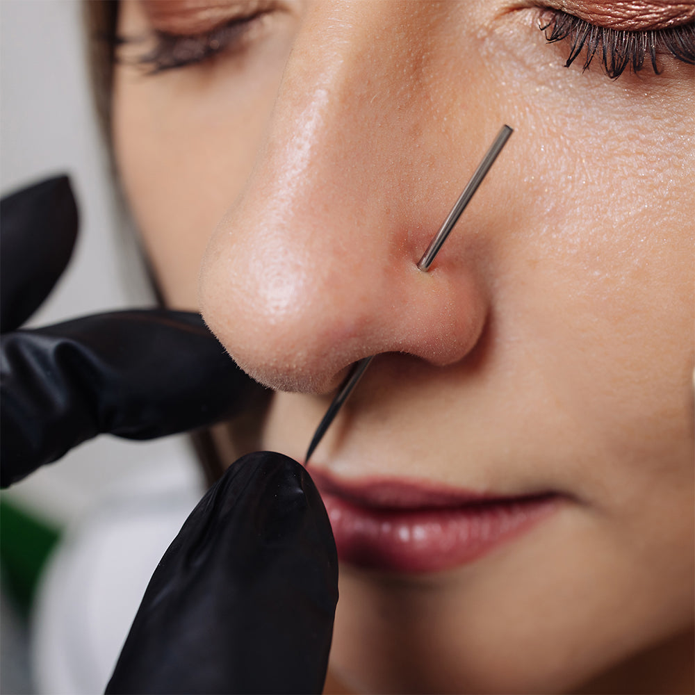 Close up of a young woman with new nose piercing